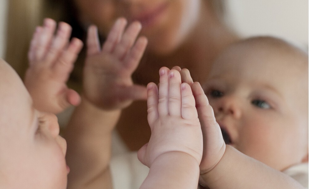 Baby touching mirror